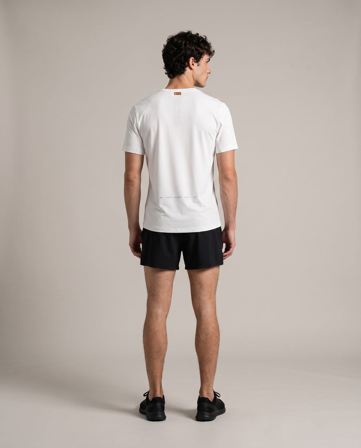 Base Run Tee — White, back, worn by an ENDUR model