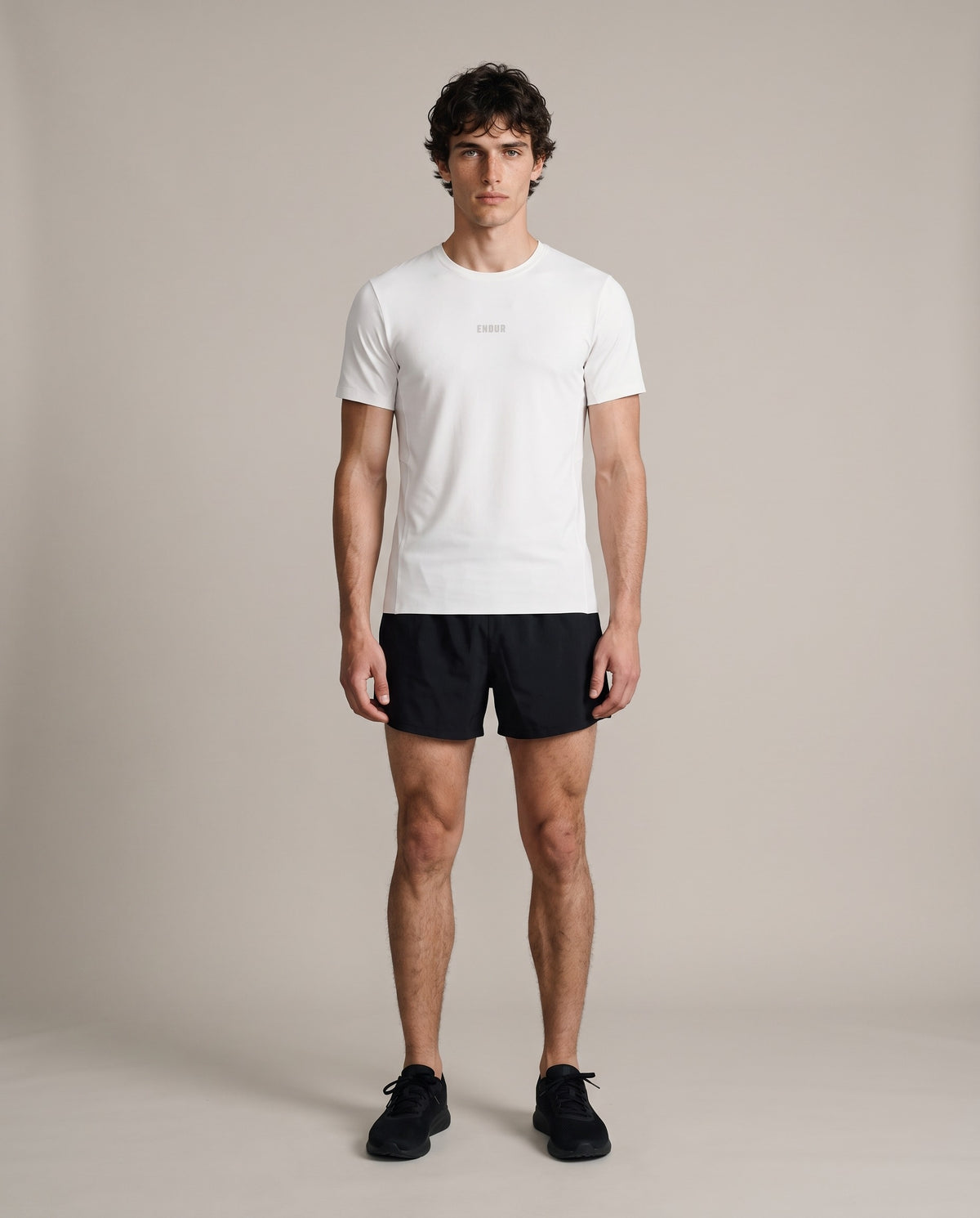 Base Run Tee — White, front, worn by an ENDUR model