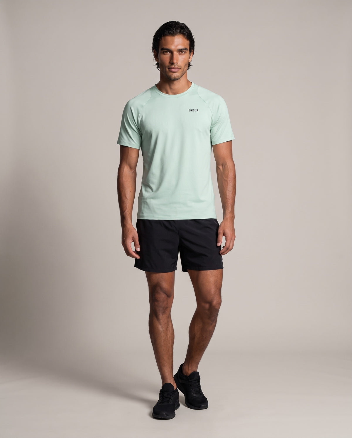 Dune Dots Run Tee — Light Green & Light Apricot, front, worn by an ENDUR model