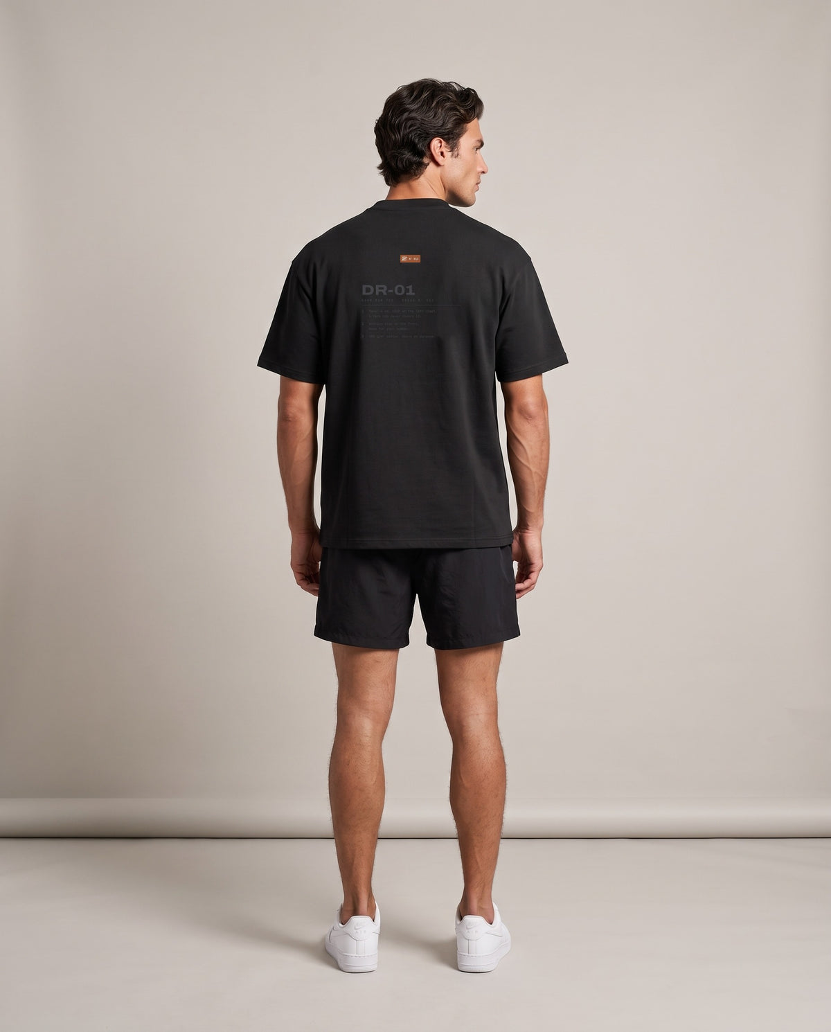 Reason Tee DR-01 — Black, back, worn by an ENDUR model