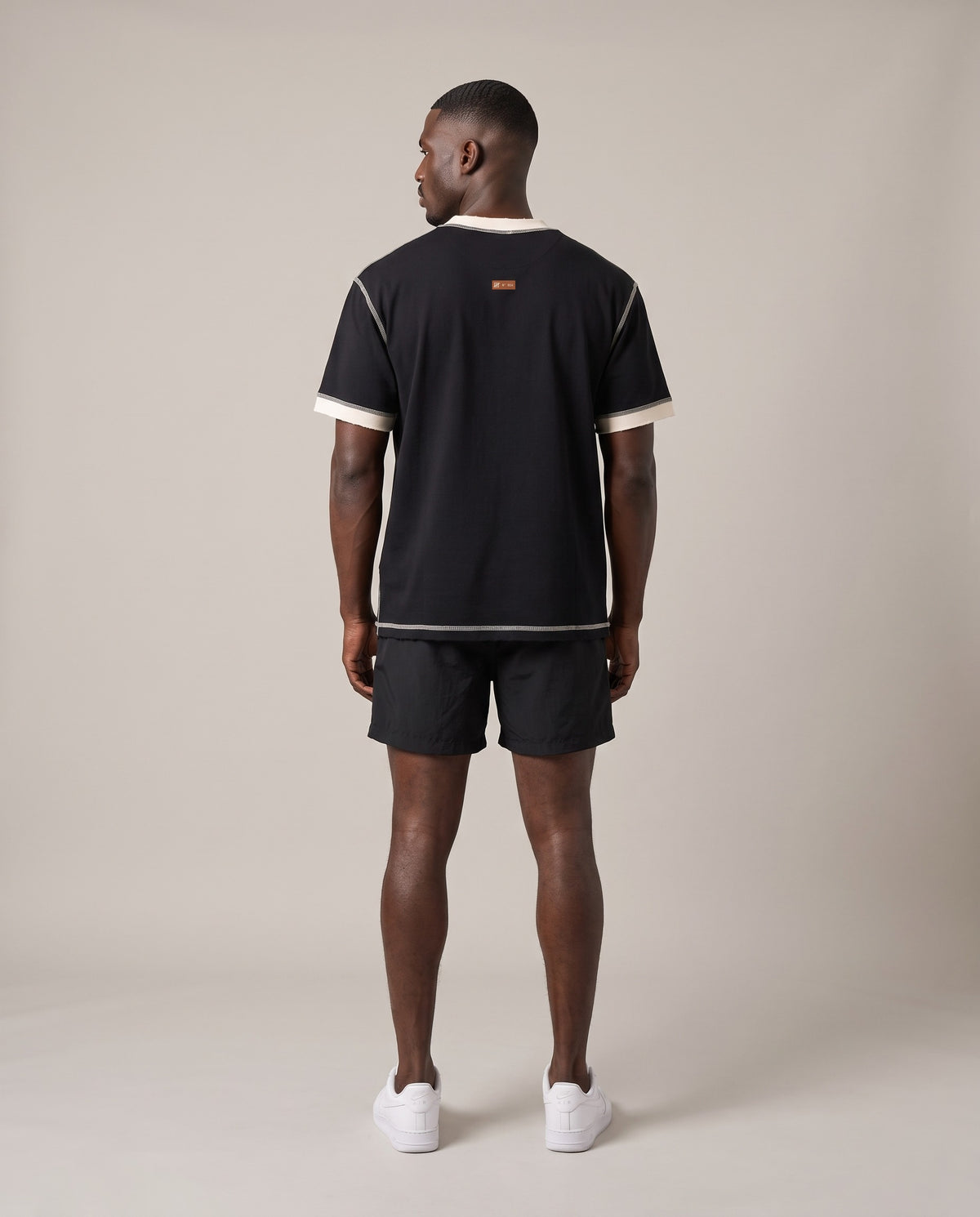 Running Club Ringer Tee — Black with Apricot, back, worn by an ENDUR model