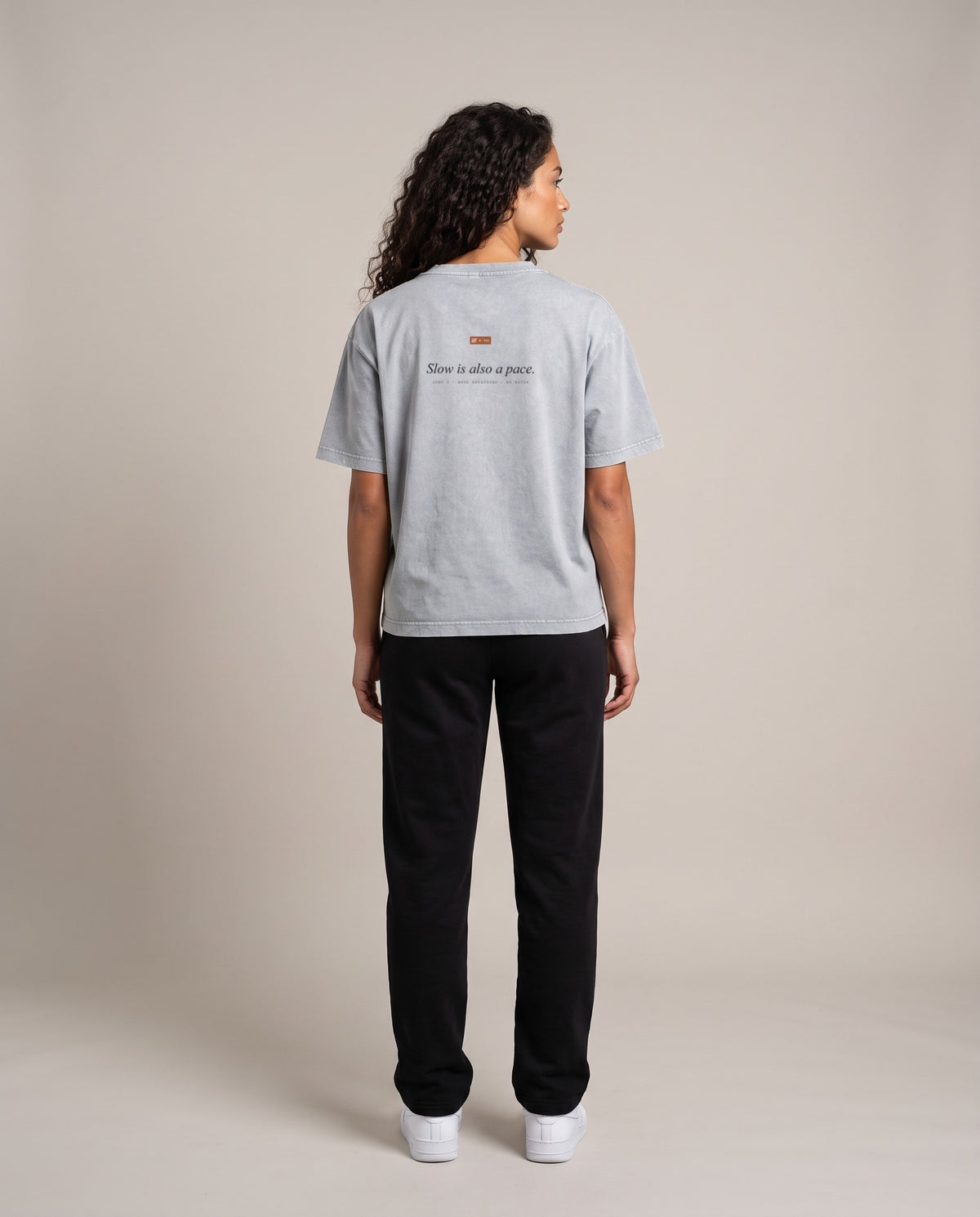 Slow Is A Pace Tee — Light Gray, back, worn by an ENDUR model