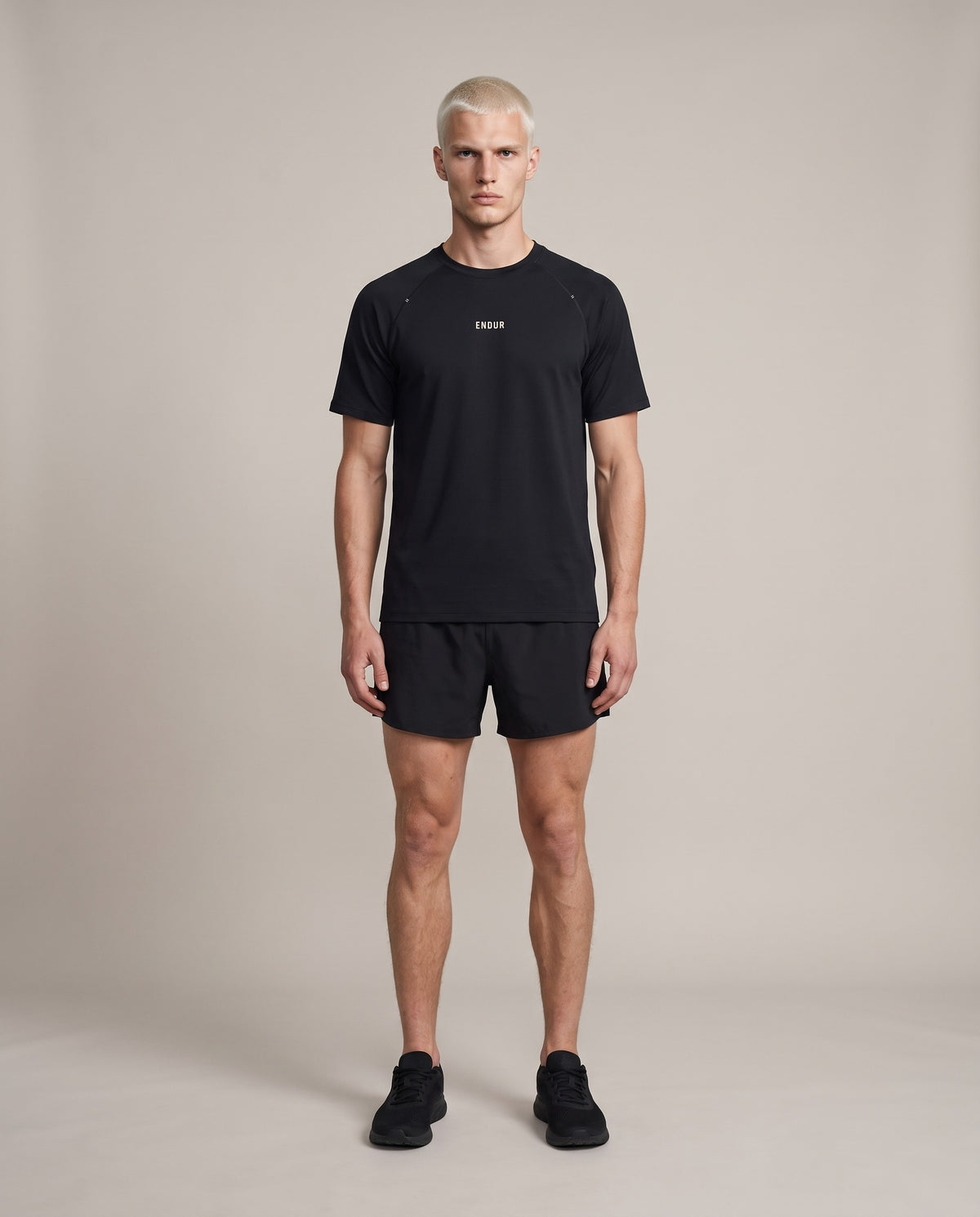 Sweat Map Run Tee — Black, front, worn by an ENDUR model