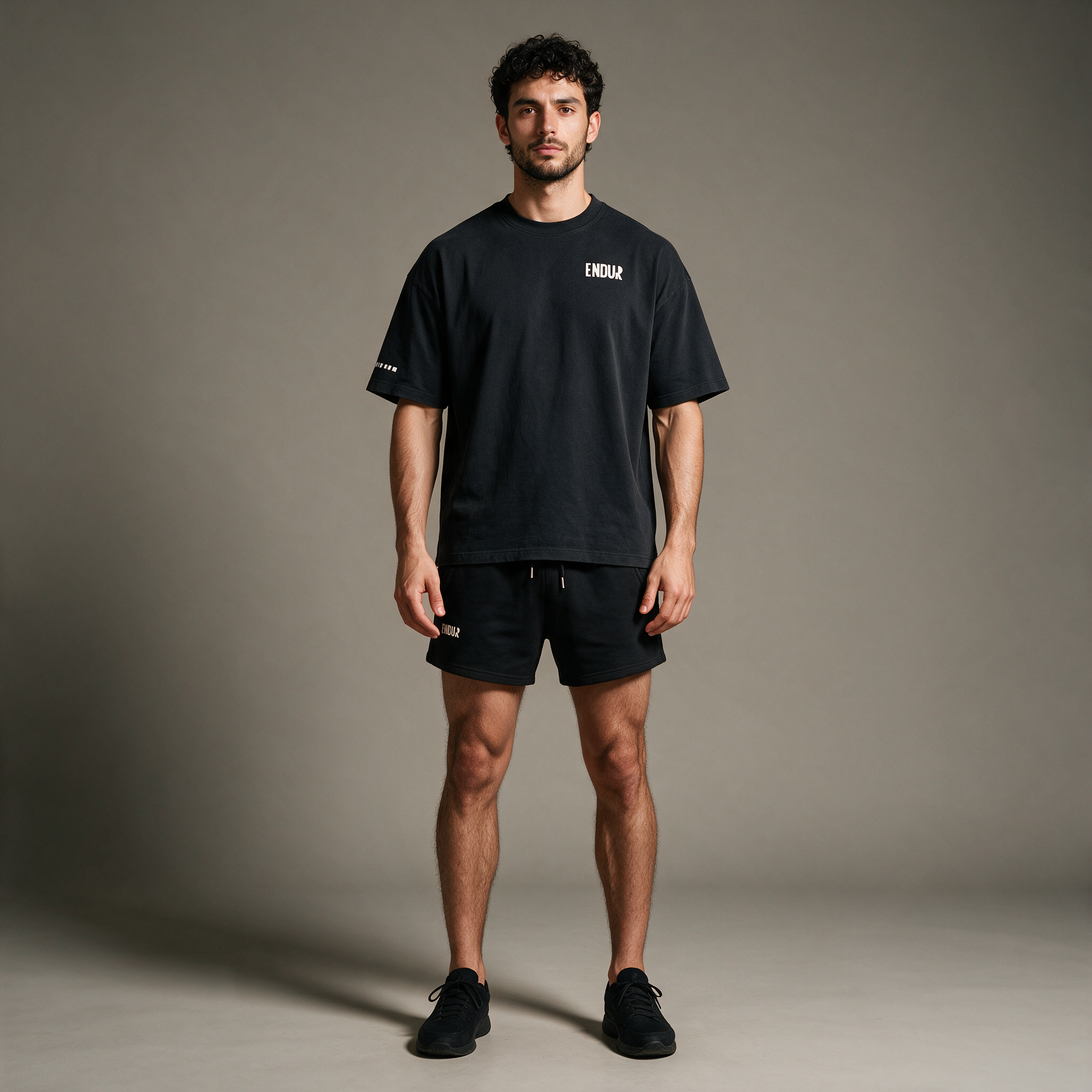 Model wearing the ENDUR Heavyweight Drawstring Shorts, studio front view