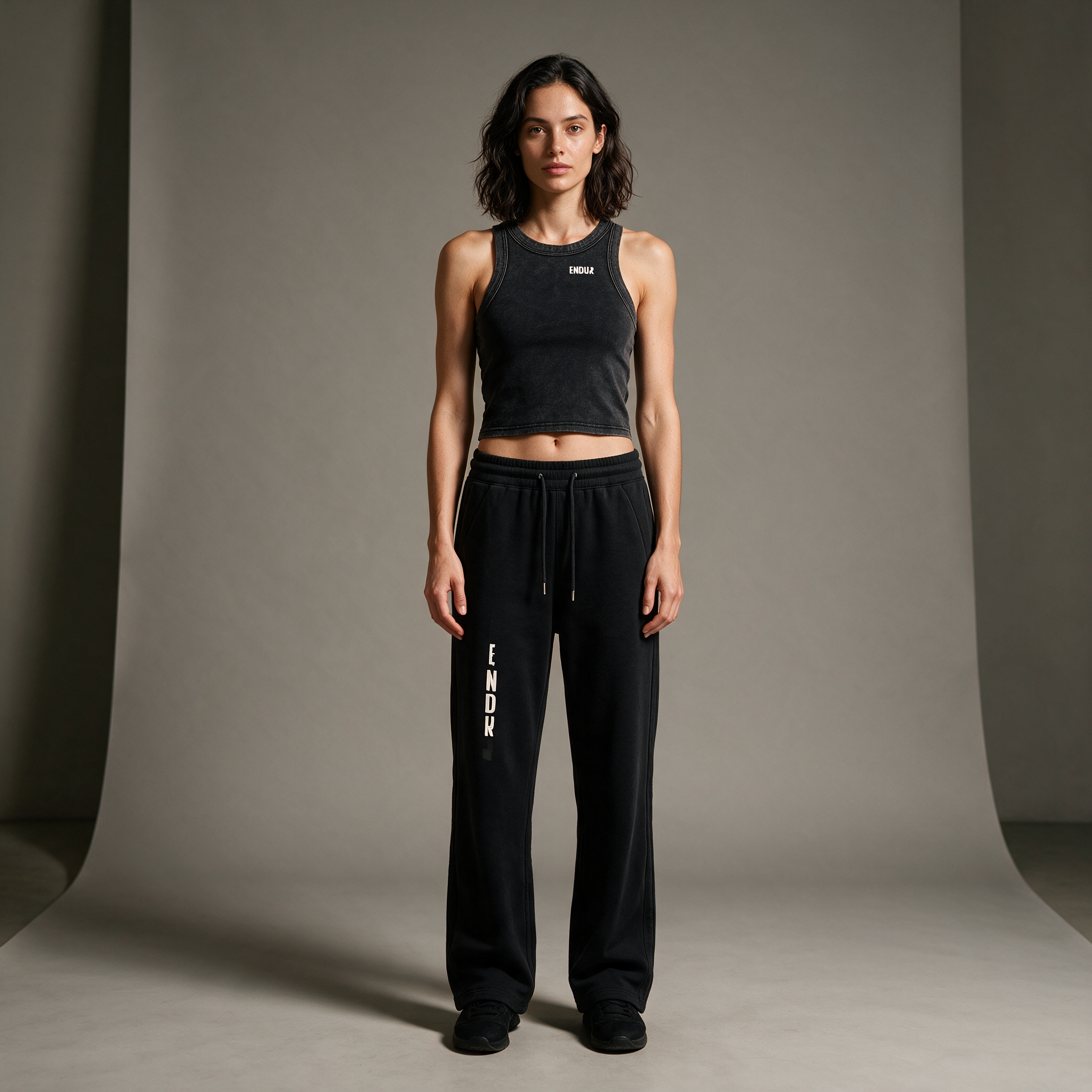 Model wearing the ENDUR Snow Wash Crop Tank Top, studio front view