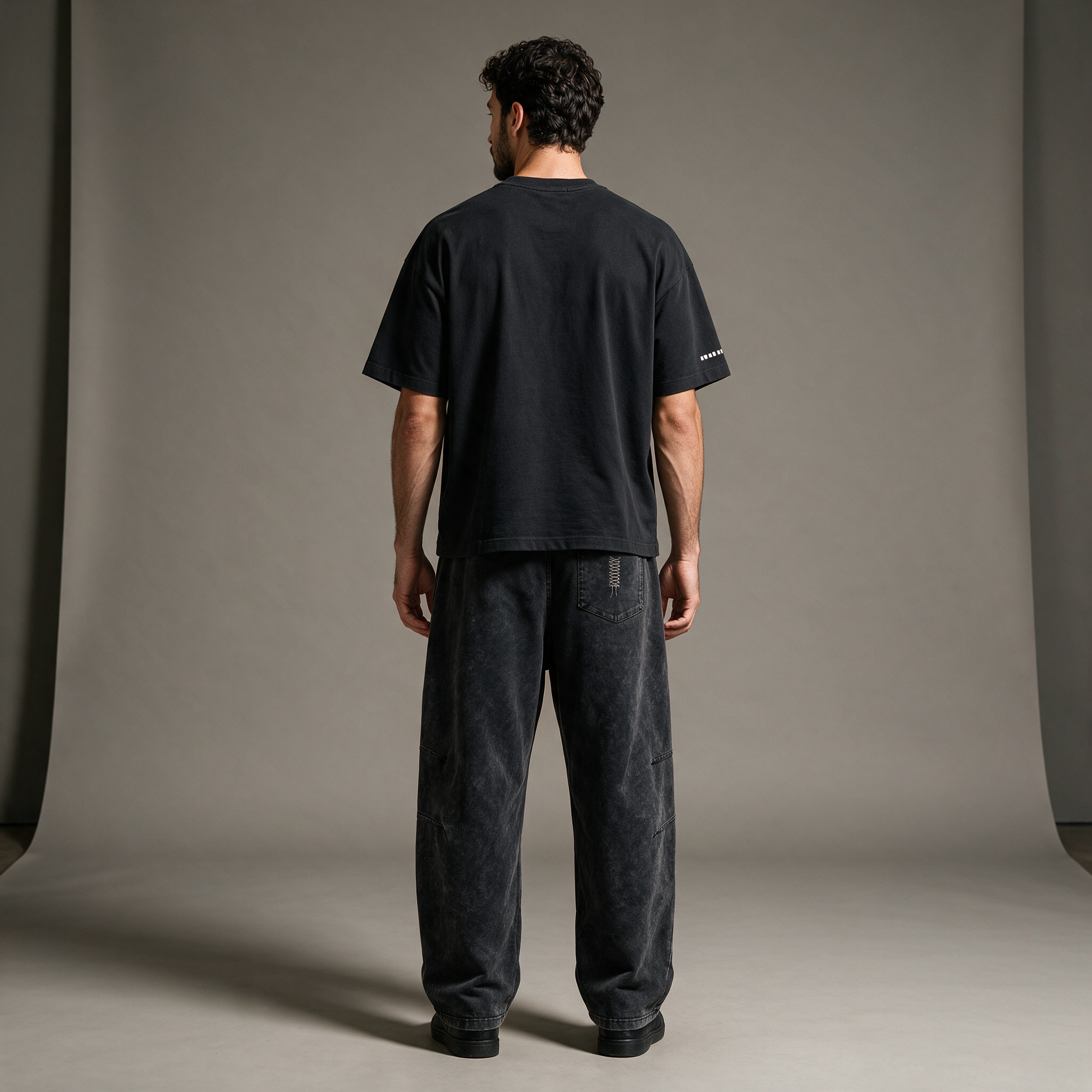 Model wearing the ENDUR Snow Wash Drawstring Pants, studio back view
