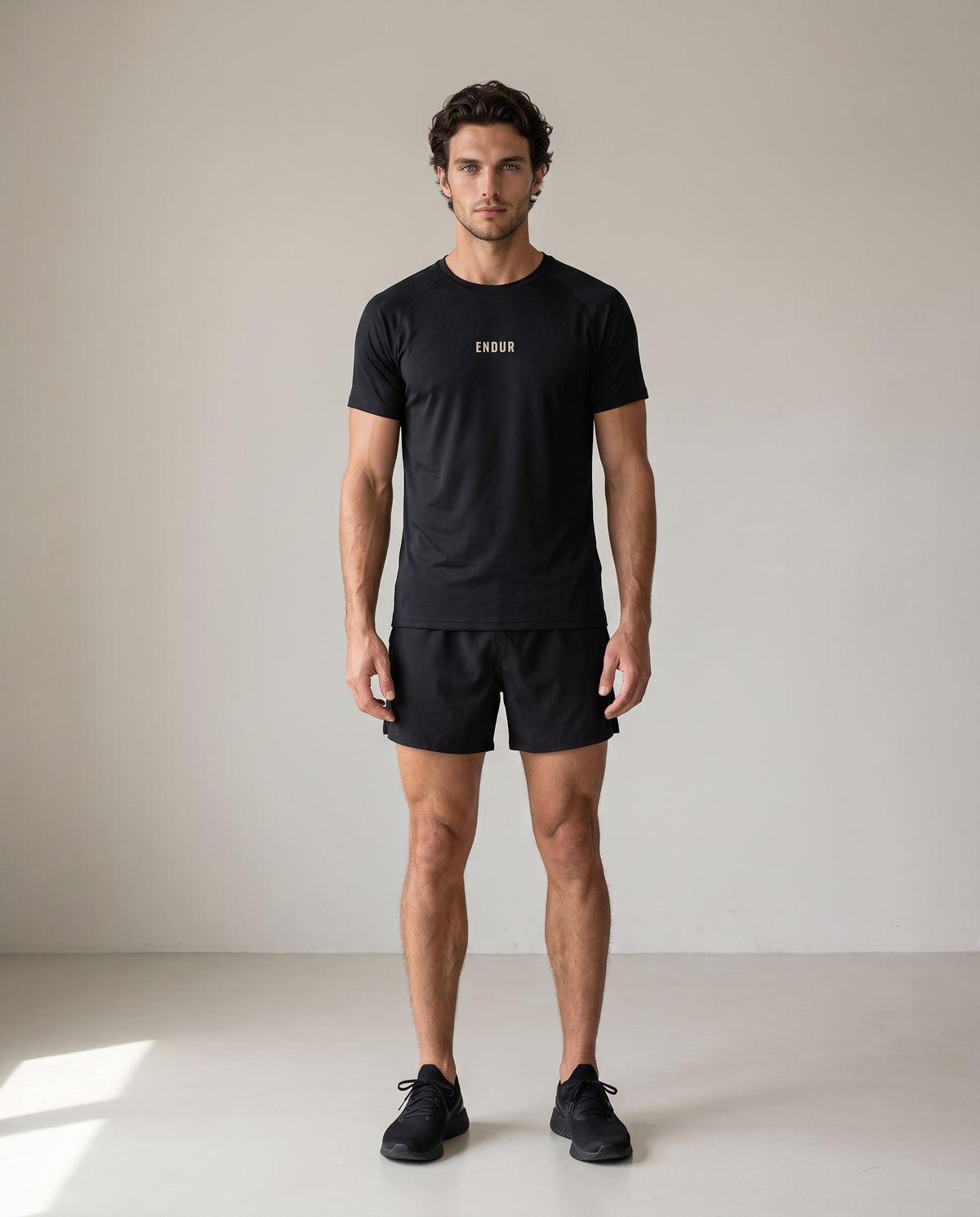 Before The Sun Run Tee — Black, front, worn by an ENDUR model