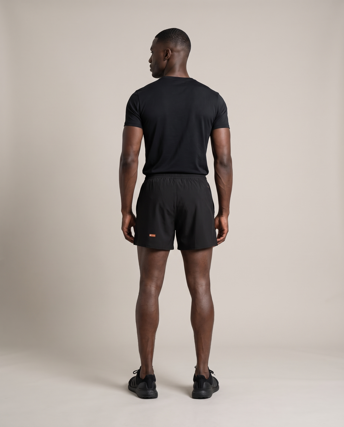 Liner Run Shorts — Black & Deep Teal, back, worn by an ENDUR model