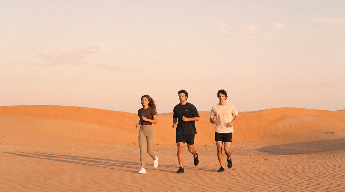 Three ENDUR runners on the dunes at sunrise